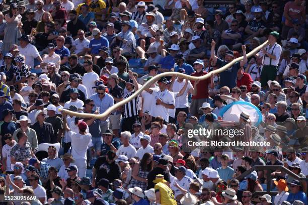 Beer snake makes it way through the cricket fans in the Western Terrace during Day Two of the LV= Insurance Ashes 3rd Test Match between England and...