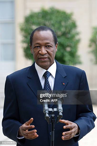 Burkina Faso's President Blaise Compaore answers journalists' questions after a meeting with France's President at the Elysee presidential palace on...