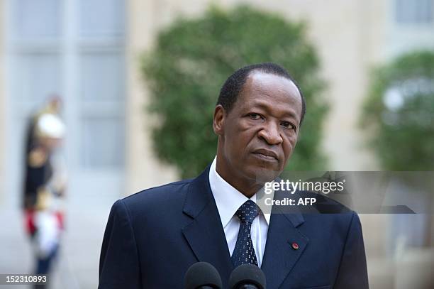 Burkina Faso's President Blaise Compaore answers journalists' questions after a meeting with France's President at the Elysee presidential palace on...