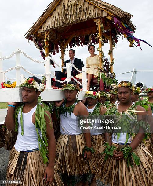 Catherine, Duchess of Cambridge and Prince William, Duke of Cambridge are carried to a welcoming ceremony when they arrive at Funafuti airport during...