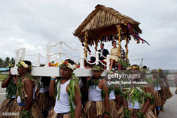 Catherine, Duchess of Cambridge and Prince William, Duke of Cambridge are carried to a welcoming ceremony when they arrive at Funafuti airport during...