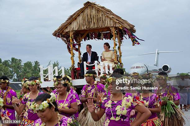 Catherine, Duchess of Cambridge and Prince William, Duke of Cambridge are carried to a welcoming ceremony when they arrive at Funafuti airport during...