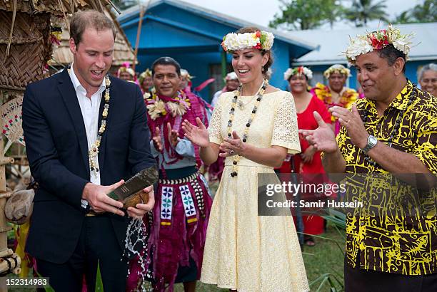 Catherine, Duchess of Cambridge watches as Prince William, Duke of Cambridge opens a coconut with a machete during the Royal couple's Diamond Jubilee...