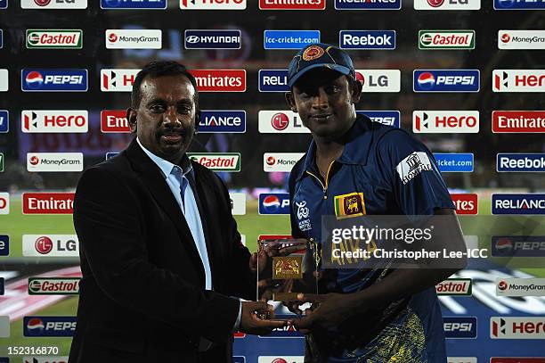 Minister of Sport Mahindananda Aluth Gamage presents Ajantha Mendis of Sri Lanka with his Player of the Match award Maduring the ICC World Twenty20...