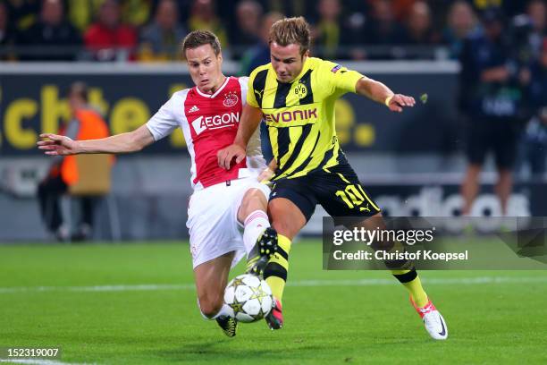 Niklas Moisander of Amsterdam challenges Mario Goetze of Dortmund during the UEFA Champions League group D match between Borussia Dortmund and Ajax...