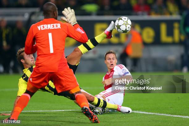 Mario Goetze of Dortmund failes against Kenneth Vermeer of Amsterdam and Niklas Moisander of Amsterdam during the UEFA Champions League group D match...