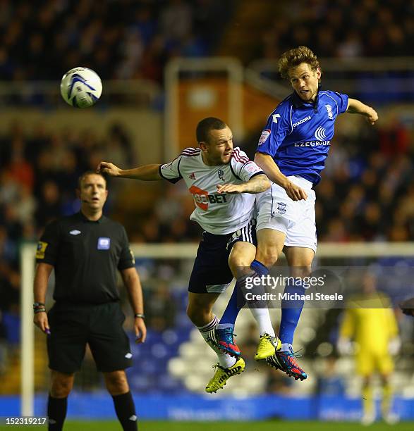 Jonathan Spector of Birmingham City rises above Jay Spearing of Bolton Wanderers during the npower Championship match between Birmingham City and...