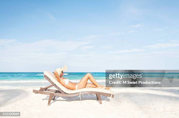 woman sunbathing beach - sun lounger 個照片及圖片檔