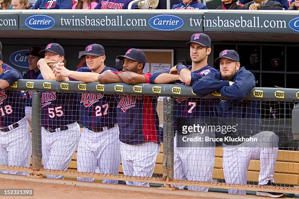 Matt Capps, Chris Parmelee, Denard Span, Joe Mauer, and Glen Perkins of the Minnesota Twins watch a ceremony to retire the number of former manager...