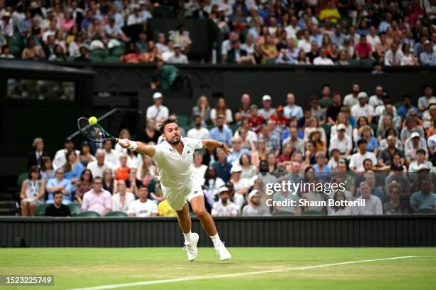 Stan Wawrinka of Switzerland plays a forehand against Novak Djokovic of Serbia in the Men's Singles third round match during day five of The...