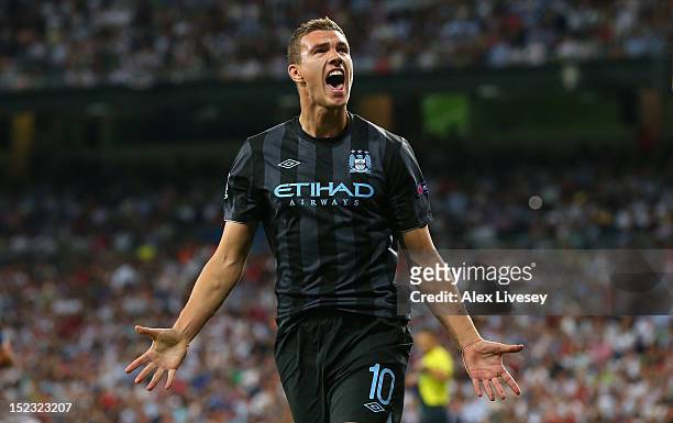 Edin Dzeko of Manchester City FC celebrates after scoring the opening goal during the UEFA Champions League Group D match between Real Madrid and...