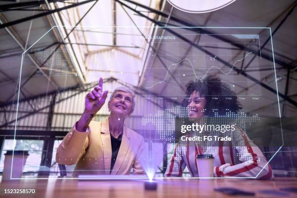 coworkers using augmented reality device during a meeting at office - augmented reality office stock pictures, royalty-free photos & images