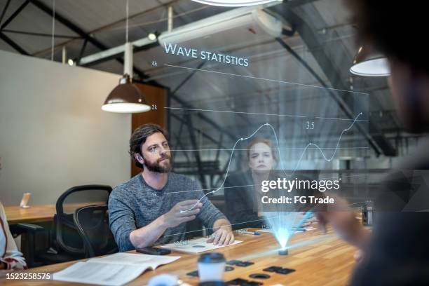 coworkers using augmented reality device during a meeting at office - data science stock pictures, royalty-free photos & images