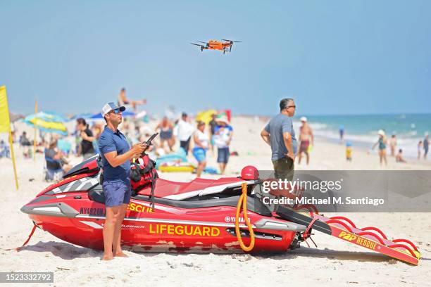 Lifeguarding supervisor Cary Epstein operates a new shark-monitoring drone at Jones Beach State Park on July 07, 2023 in Wantagh, New York. Governor...