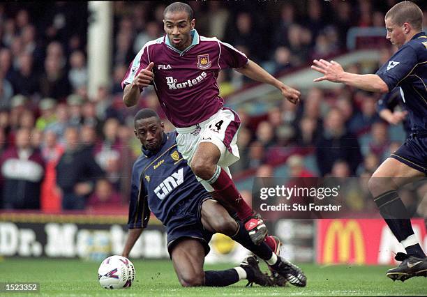 Frederic Kanoute of West Ham United beats the challenge of Wimbledon`s Jason Euell during the FA Carling Premiership match at Upton Park in London....