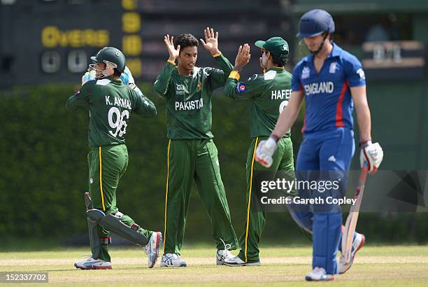 Raza Hasan of Pakistan celebrates with teammates after dismissing Craig Kieswetter of England during the ICC T20 World Cup Warm Up Match between...