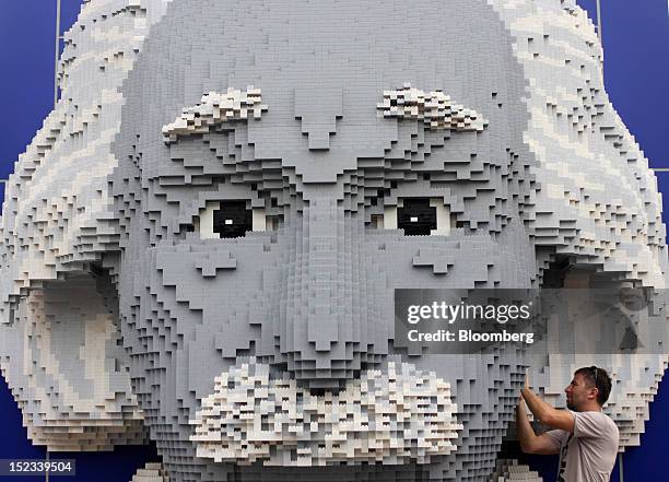 Builder makes final adjustments to a Lego display of Albert Einstein at Legoland Malaysia, operated by Themed Attractions and Resorts Sdn., in Kota...