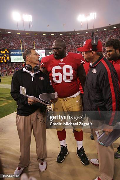 Offensive Line Coach Mike Solari of the San Francisco 49ers talks with Leonard Davis during the game against the Detroit Lions at Candlestick Park on...