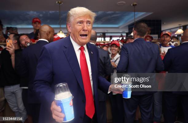 Former US President Donald Trump hands out Blizzards and milkshakes during a stop at a DQ restaurant after speaking at a Farmers for Trump campaign...