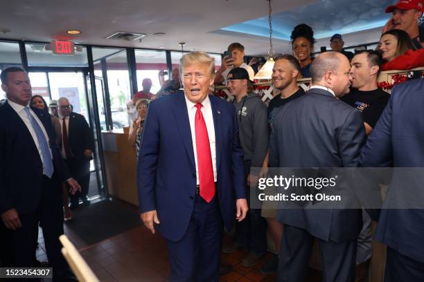 Former US President Donald Trump arrives at a DQ restaurant where he passed out Blizzards and milkshakes to guests on July 07, 2023 in Council...