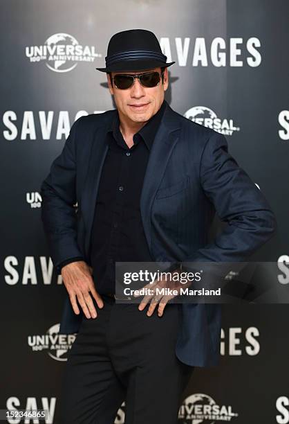 John Travolta attends a photocall for new film 'Savages' at The Mandarin Oriental on September 19, 2012 in London, England.