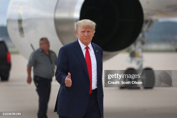 Former US President Donald Trump prepares to board his jet at the airport after holding a campaign event in Nearby Council Bluffs, Iowa on July 07,...