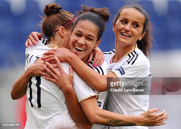 Anja Mittag of Germany celebrates with Celia Okoyino da Mbabi and Fatmire Bajramaj after scoring his teams second goal during the UEFA Womens Euro...