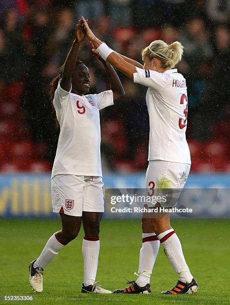 Eniola Aluko and Stephanie Houghton of England celebrate victory at the final whistle during the UEFA Women's EURO 2013 Group 6 Qualifier between...