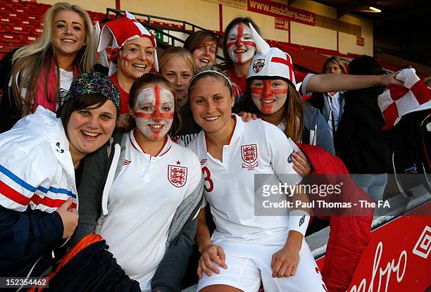 Stephanie Houghton of England poses for a photograph with fans after the UEFA European Women's 2013 Championship Qualifier between England and...