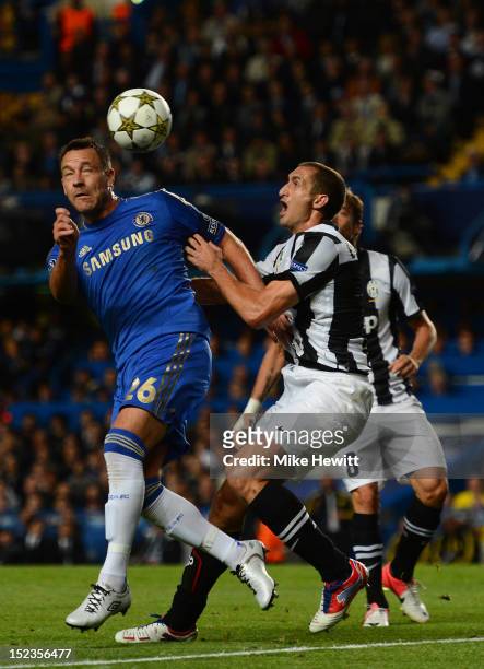John Terry of Chelsea is put under pressure by Giorgio Chiellini of Juventus during the UEFA Champions League Group E match between Chelsea and...