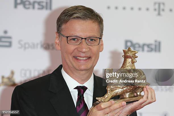 Guenther Jauch holds up his award at 'Goldene Henne' 2012 award on September 19, 2012 in Berlin, Germany.