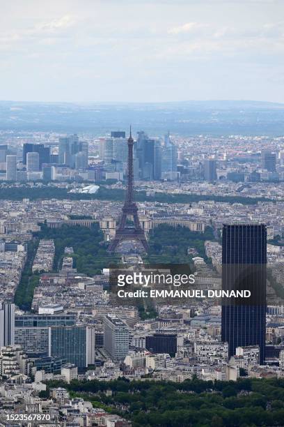 This aerial photograph taken on July 11 onboard a helicopter of French army, shows the Eiffel Tower and the Tour Montparnasse , three days ahead of...