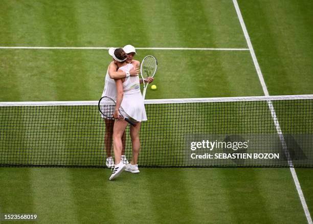 Ukraine's Elina Svitolina hugs Poland's Iga Swiatek after winning their women's singles quarter-finals tennis match on the ninth day of the 2023...