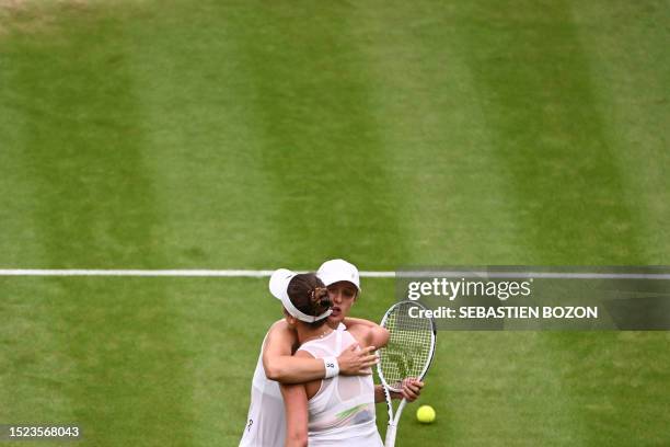 Ukraine's Elina Svitolina hugs Poland's Iga Swiatek after winning their women's singles quarter-finals tennis match on the ninth day of the 2023...