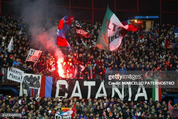 Catania supporters with a torch cheer during the football match between Catania and Palermo at Catania's Massimino stadium, 02 february 2007. An...