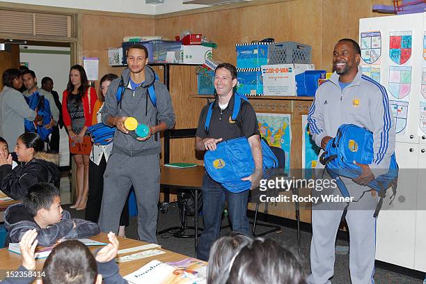 Golden State Warriors guard Stephen Curry and Assistant Coaches Darren Erman and Kris Weems visit students at Garfield Elementary on September 17,...
