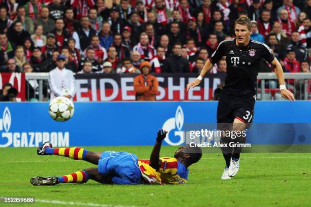 Bastian Schweinsteiger of Muenchen scores his team's first goal against Aly Cissokho of Valencia during the UEFA Champions League group F match...