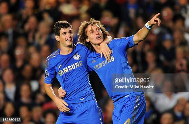 Oscar of Chelsea celebrates scoring their first goal with David Luiz of Chelsea during the UEFA Champions League Group E match between Chelsea and...