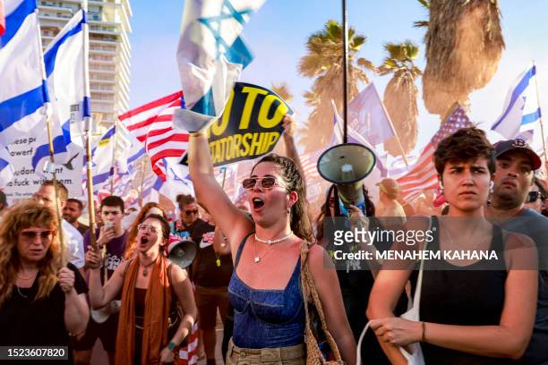 Demonstrators rally with US and Israeli flags during a protest against the Israeli government's judicial overhaul bill outside the US Embassy Tel...