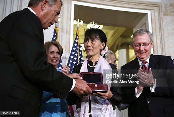 Burmese opposition politician Aung San Suu Kyi is presented with a U.S. Congressional Gold Medal by Speaker of the House Rep. John Boehner as House...