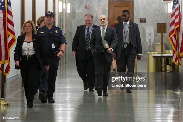 Ben S. Bernanke, chairman of the U.S. Federal Reserve, center, walks to a Senate Finance Committee meeting on Capitol Hill in Washington, D.C., U.S.,...