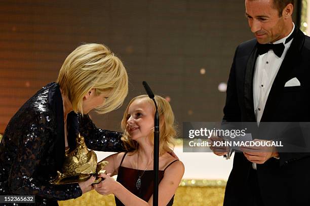 German TV host Carmen Nebel receives her award during the Golden Hen media prize awards ceremony on September 19, 2012 in Berlin. AFP PHOTO POOL /...