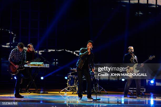 German singer Andreas Bourani and band perform during the Golden Hen media prize awards ceremony on September 19, 2012 in Berlin. AFP PHOTO POOL /...