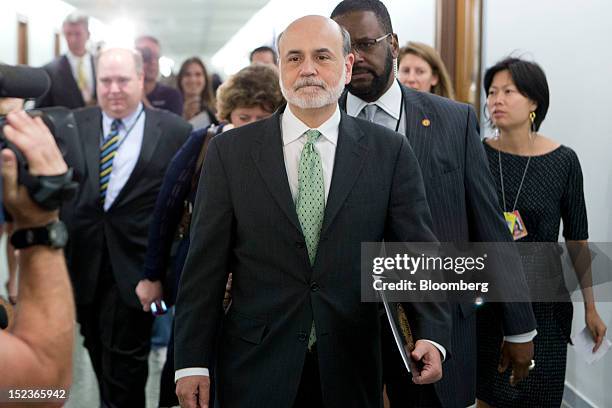 Ben S. Bernanke, chairman of the U.S. Federal Reserve, center, leaves following a Finance Committee meeting on Capitol Hill in Washington, D.C.,...