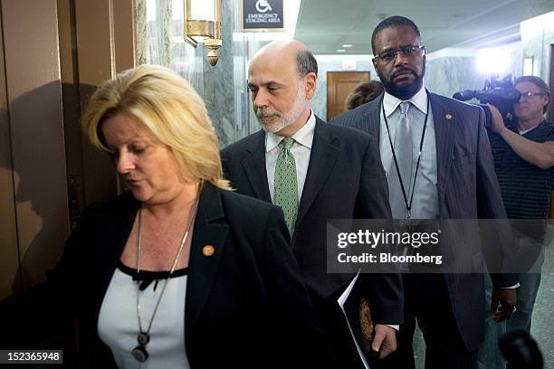 Ben S. Bernanke, chairman of the U.S. Federal Reserve, center, leaves following a Finance Committee meeting on Capitol Hill in Washington, D.C.,...