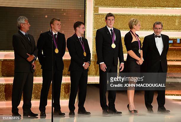 Members of the Canoe Club Potsdam stand next to Brandenburg State Premier Matthias Platzeck at the Golden Hen media prize awards ceremony on...
