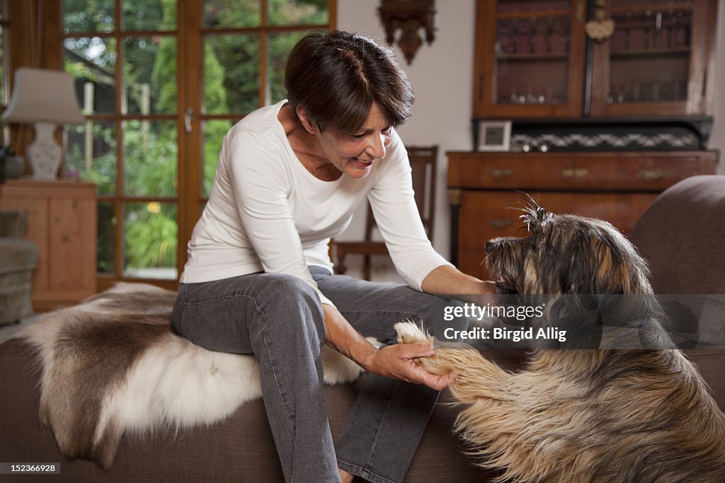 Senior woman teaching dog