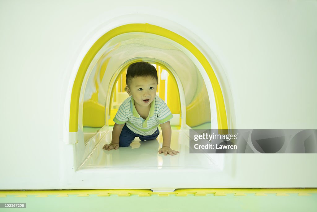 Boy in toy tunnel