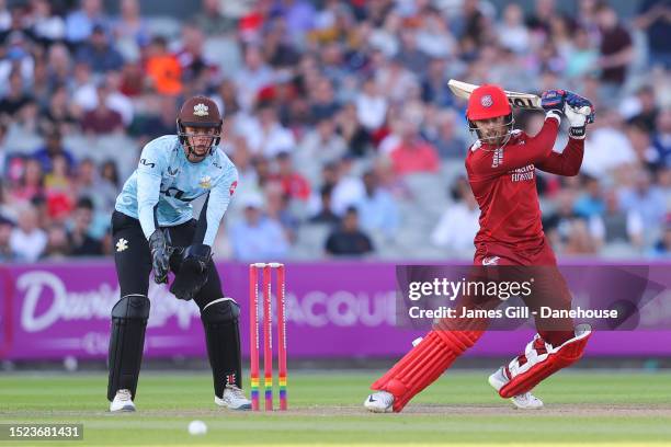 Phil Salt of Lancashire strikes the ball as Jamie Smith of Surrey watches on during the Vitality T20 Blast quarter-final match between Lancashire...