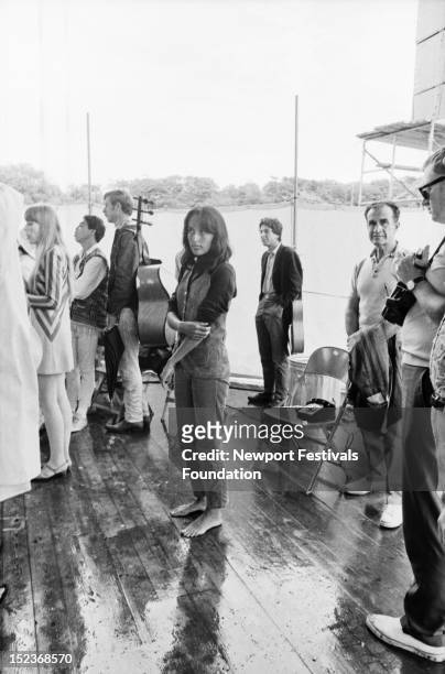 Folk singer and activist Joan Baez backstage at the Newport Folk Festival in July, 1967 in Newport, Rhode Island. Sharing the backstage area with Ms...